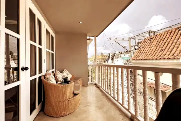 Balcony with seating and a view over terracotta rooftops