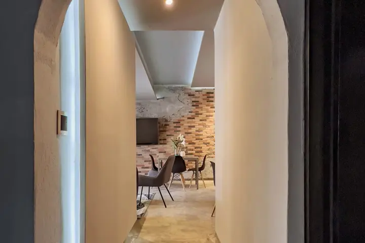 Hallway with curved walls leading to the dining area