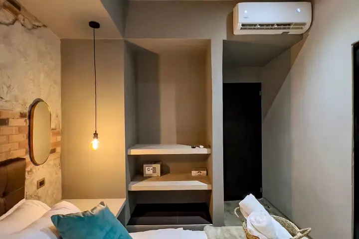 Bedroom with built-in shelves and an air conditioning unit