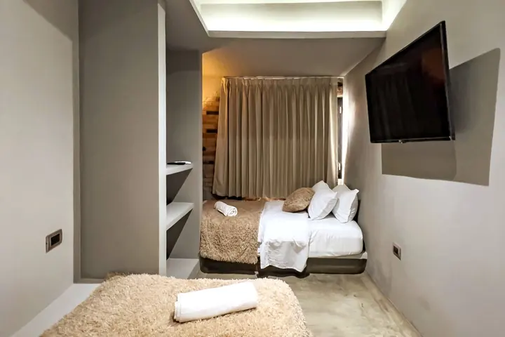 Bedroom with two single beds seen towards the window