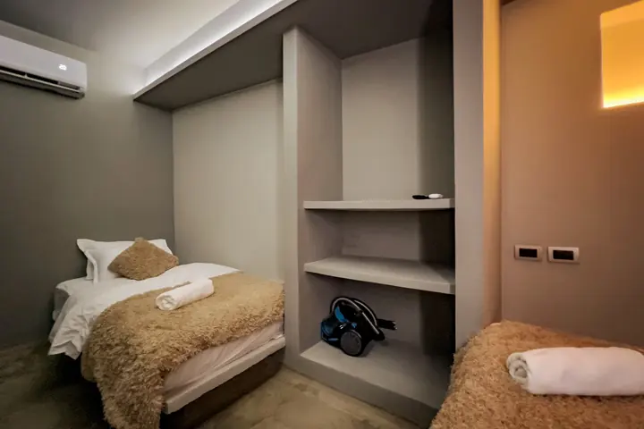 Single bed with a fleece throw and built-in shelving