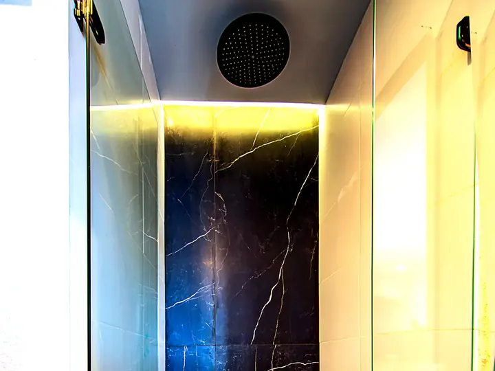Rain shower with dark marble-effect wall