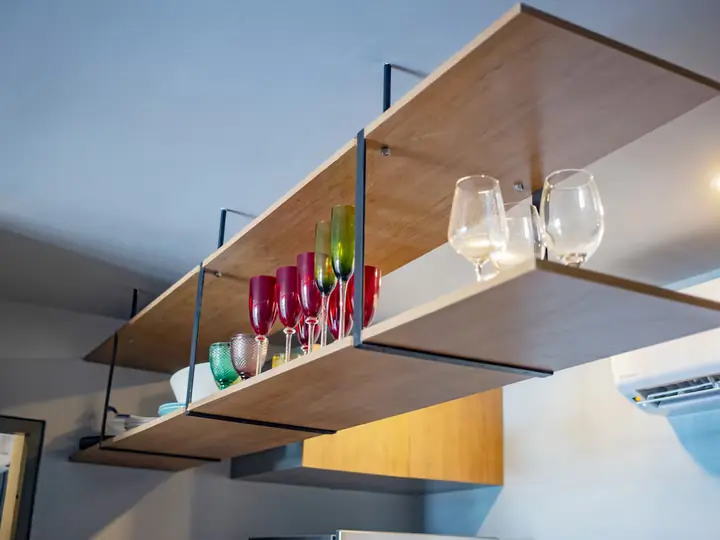 Hanging shelf with wine glasses and coloured glassware