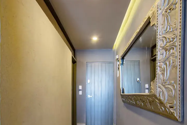 Entrance hallway with an ornate framed mirror