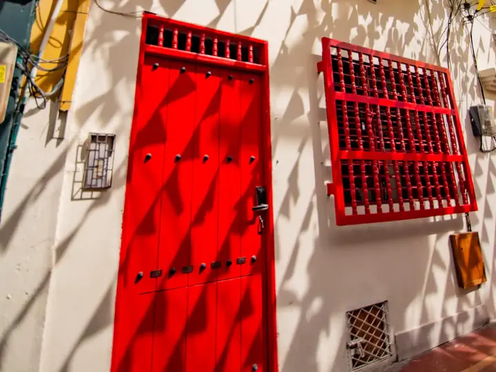 Red wooden front door of the building